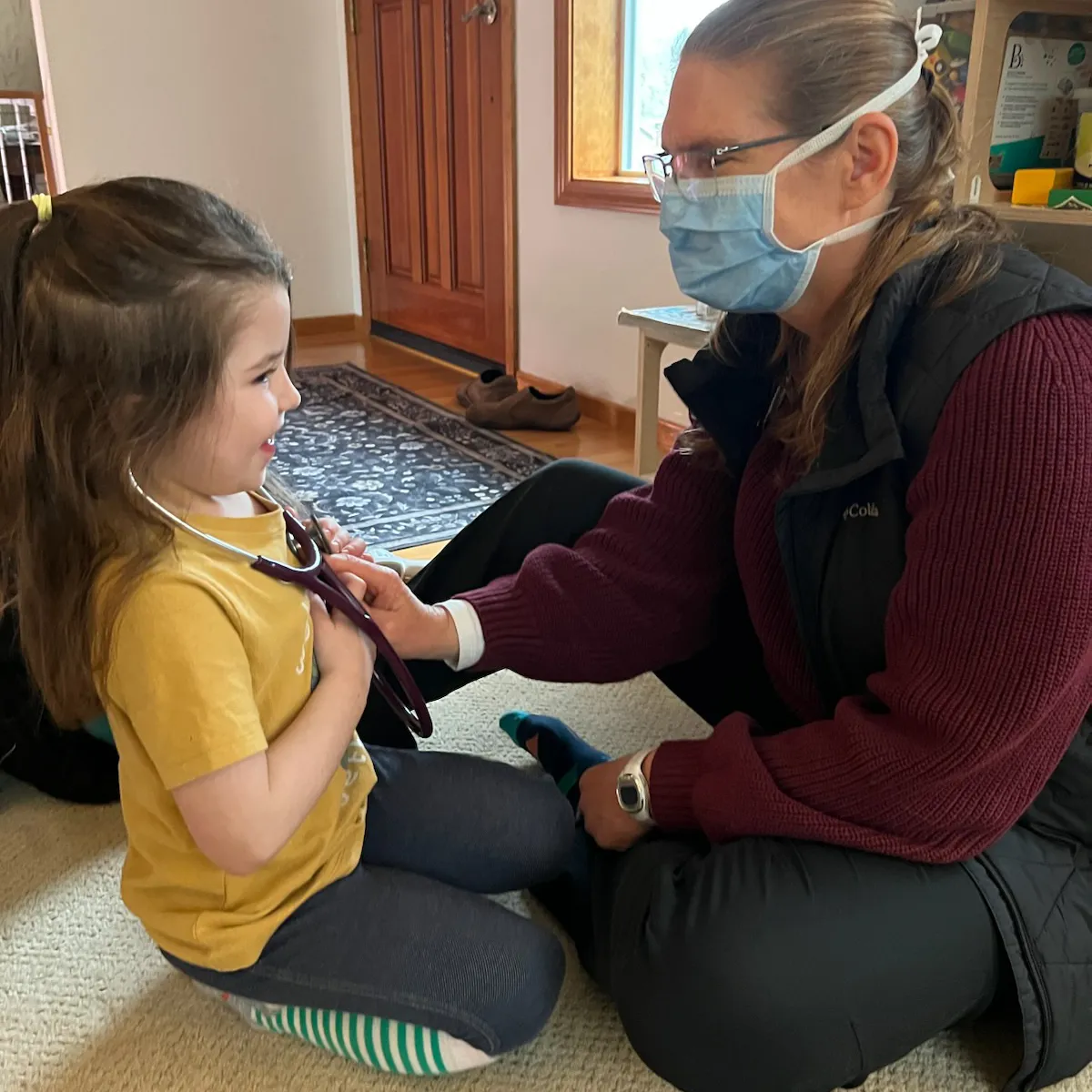 Dr. Rivers examining a child at home